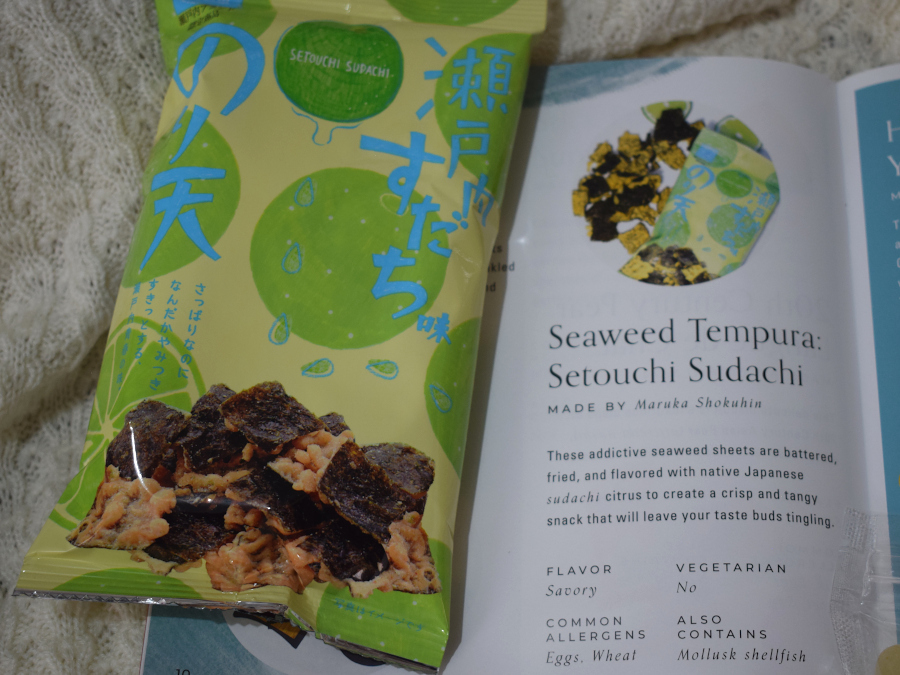 One packed of battered fried seaweed chips next to a leaflet describing it