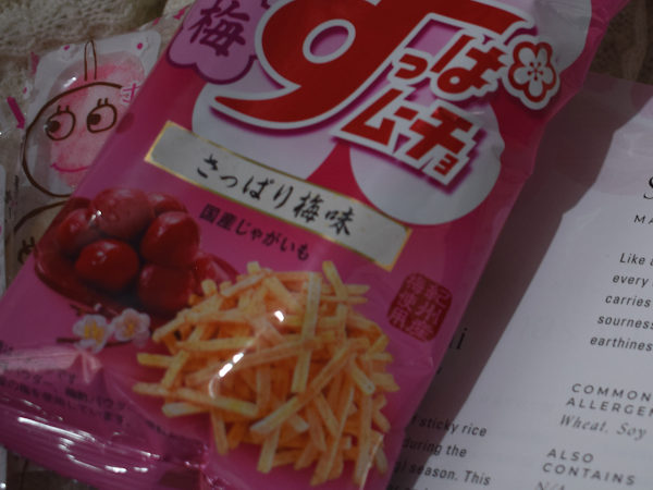 A packet of pink potato chips next to a leaflet describing it