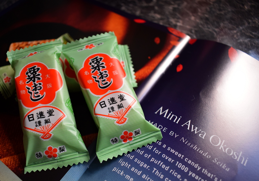 three sweet puffed rice cake bars next to a leaflet describing them