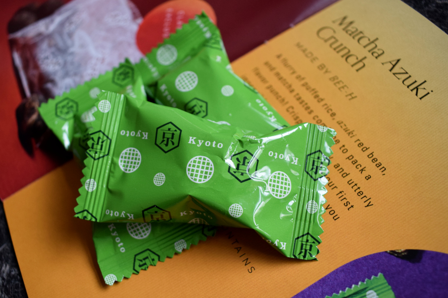 three packets of asuki matcha rice cakes next to a leaflet describing them